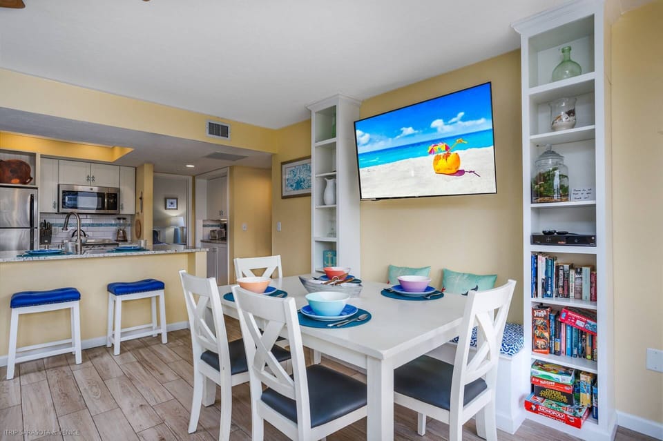 Dining table seats 6 people comfortably with additional seating on the balcony plus 2 kitchen counter seats