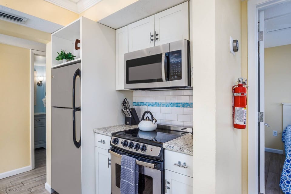 Beautifully updated, modern kitchen stocked with dishes, glasses and includes a coffee bar