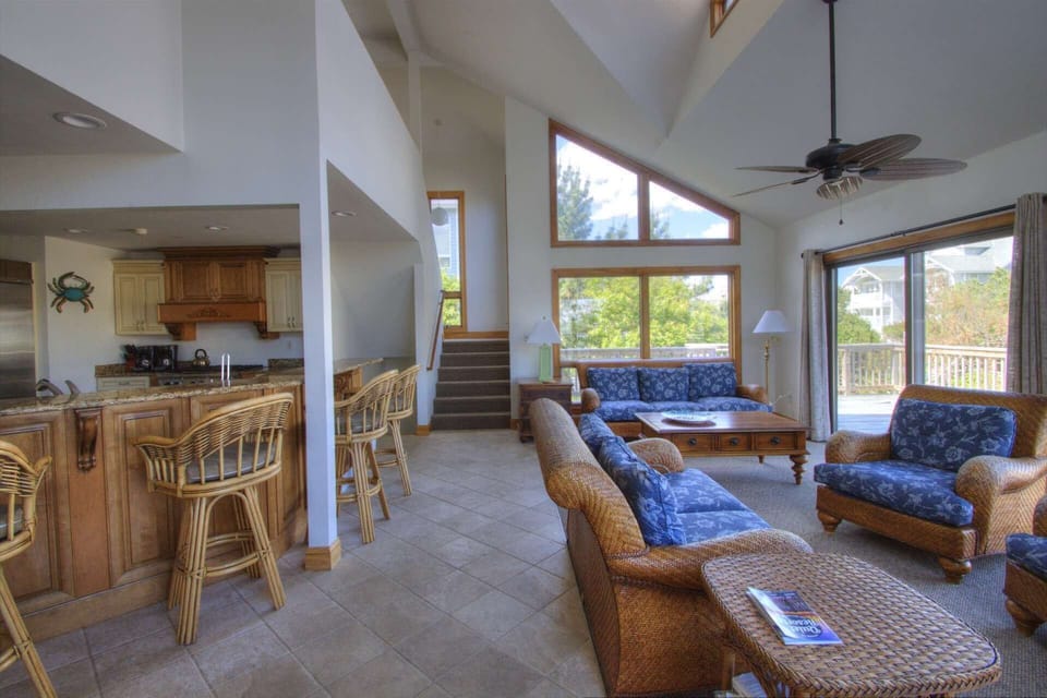 Open concept huge living room, kitchen and dining area with bright sunny views.