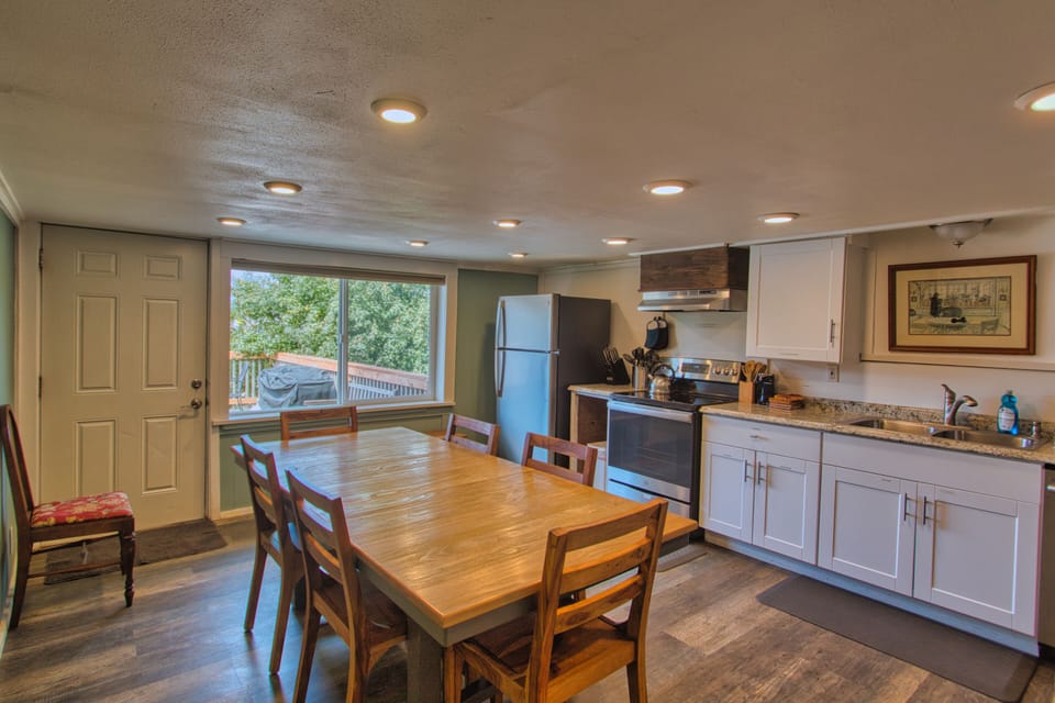 The dining area showcases a wooden table with seating for six.