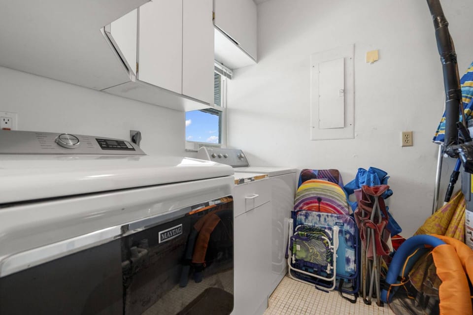 Laundry Room in Unit with Full Size Washer and Dryer and Beach Gear for Guests' Use