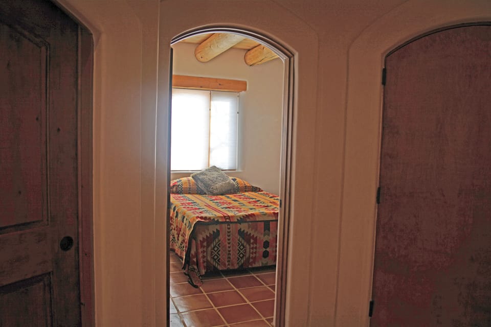 Queen guest bedroom showing one of the many arched door ways