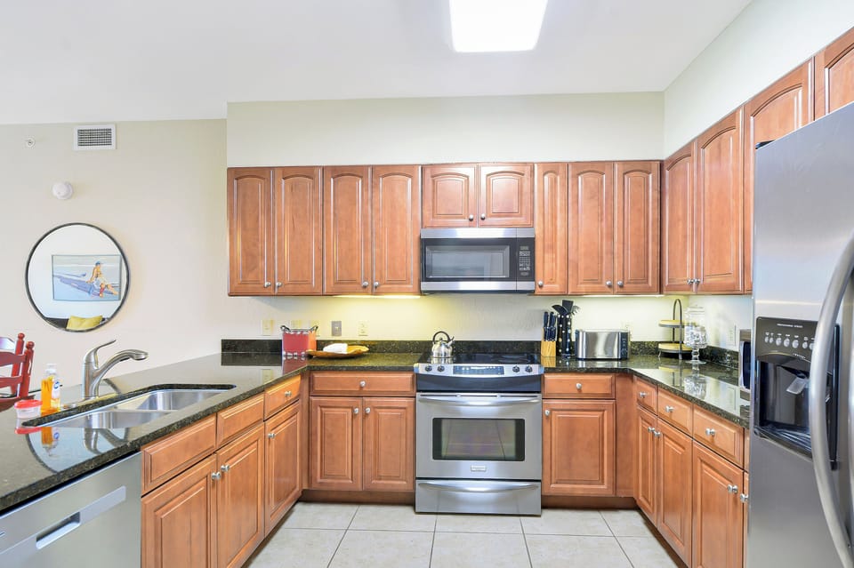 Kitchen with Granite Counters - Full kitchen with stainless appliances, granite counters, microwave, dishwasher, and cabinet storage.