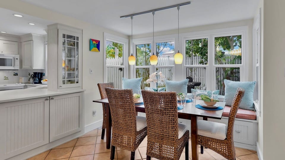 Gather around this bright dining nook where your meals become memories, bathed in natural light from expansive windows.