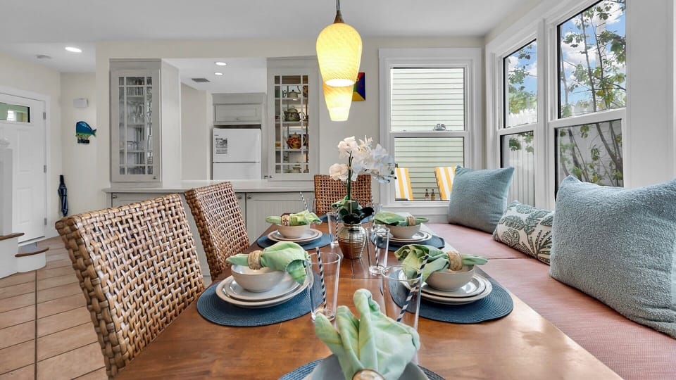 Gather around your beautifully set dining table for memorable meals together, with warm wood tones and coastal touches creating the perfect atmosphere.