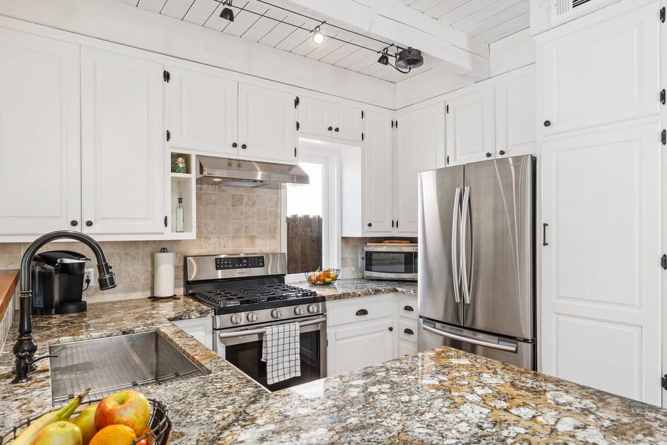 Kitchen with granite top, stainless sink and appliances