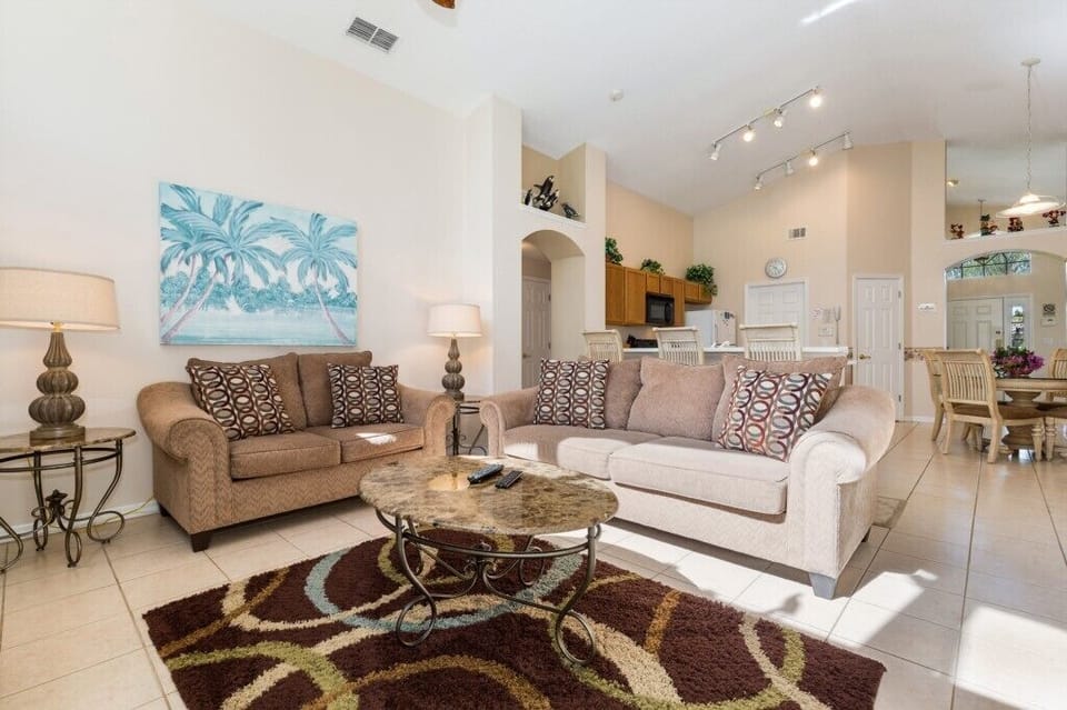 Stylish living area with cozy seating, bright decor, and a welcoming atmosphere for relaxation.
