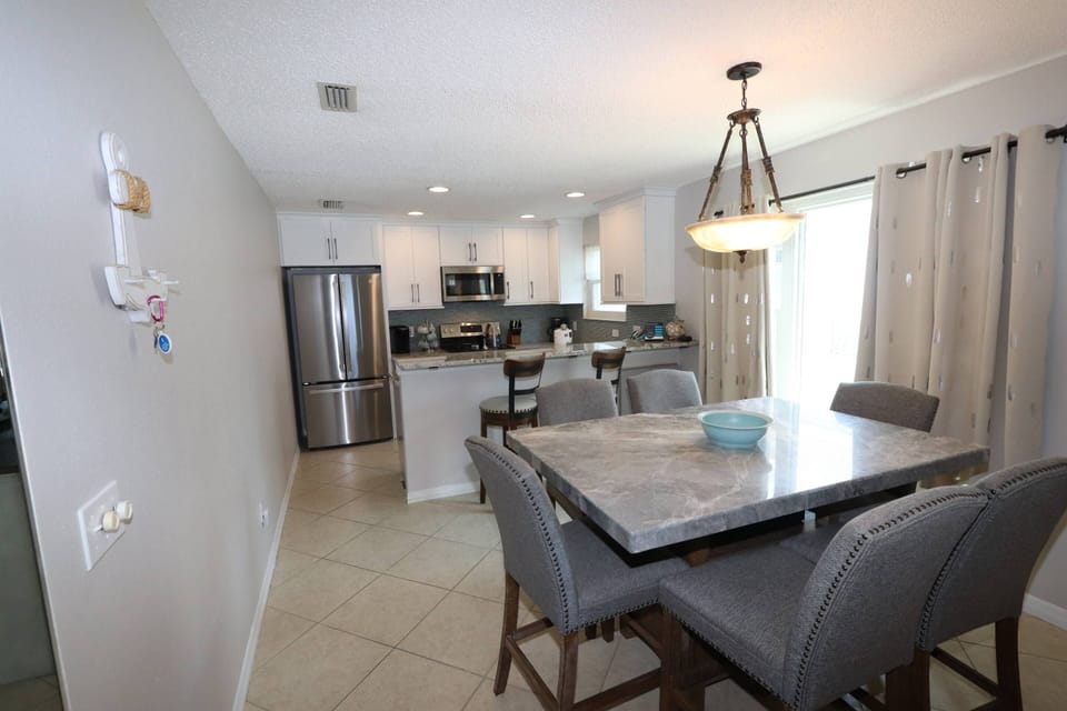 Updated Kitchen with Stainless Steel Appliances and Dining Room with Bar Height Dining Table with Seating for 6