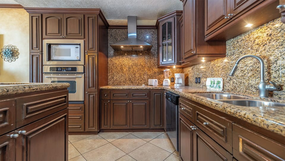 The full kitchen is elegant and offers a great place for meal preparation.