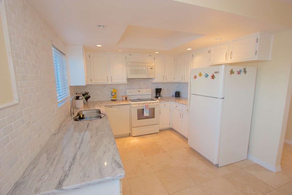 Pack a lunch for the family or enjoy whipping up a an amazing meal in this beautifully updated and stocked kitchen with brand new granite counter tops