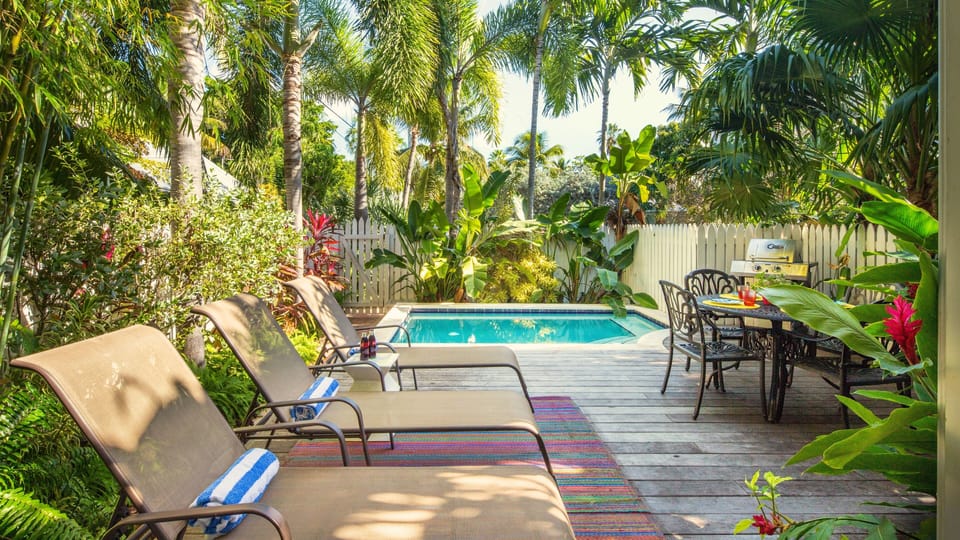 The private saltwater dip pool is heat-optional and surrounded by lush landscaping...