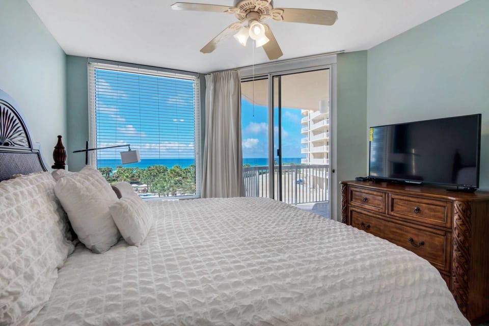 Master Bedroom ~ King Bed with Access to Private Balcony, Flat screen TV, Ceiling Fan, Walk-in Closet & Ensuite Bathroom
