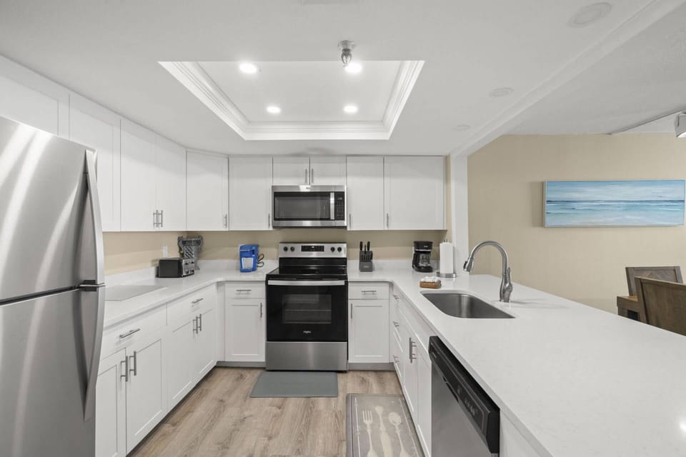 Updated Kitchen with Sleek White Cabinets and Stainless-Steel Appliances