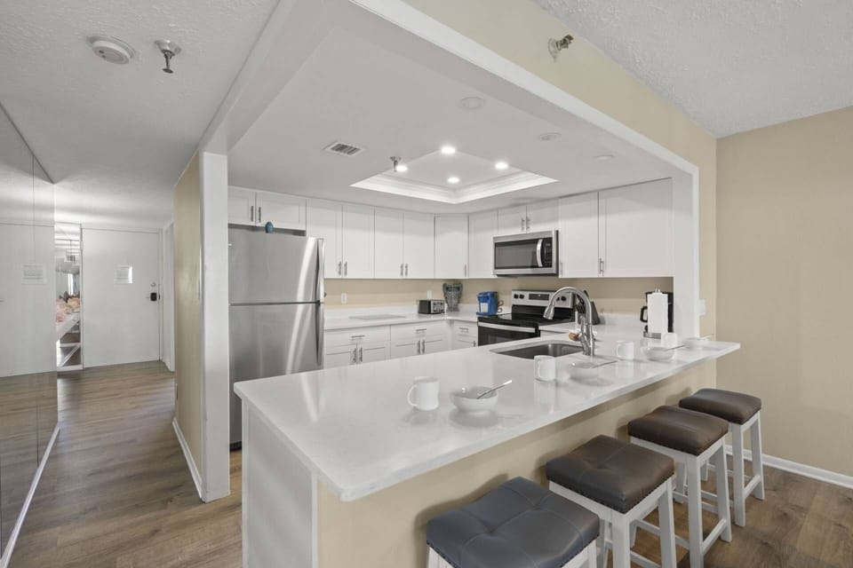 Updated Kitchen with Sleek White Cabinets and Stainless-Steel Appliances