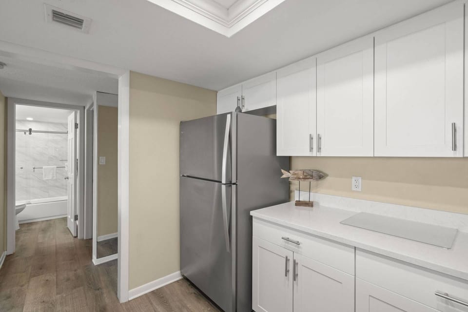 Updated Kitchen with Sleek White Cabinets and Stainless-Steel Appliances