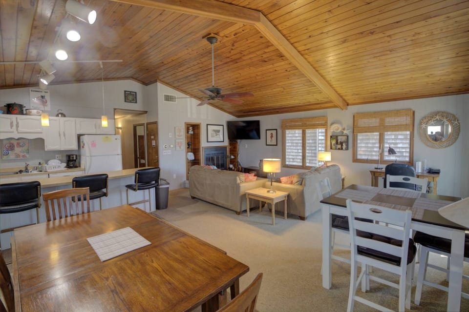 Freshly painted, large open living room, dining room, and kitchen.