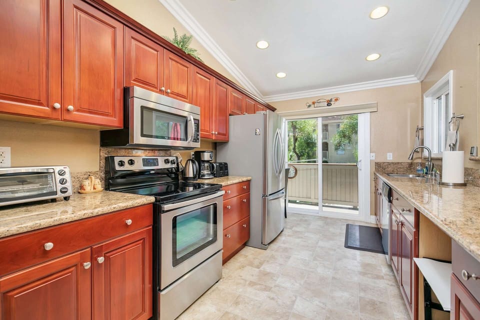 Updated kitchen with custom cabinetry, granite counters, and stainless appliances