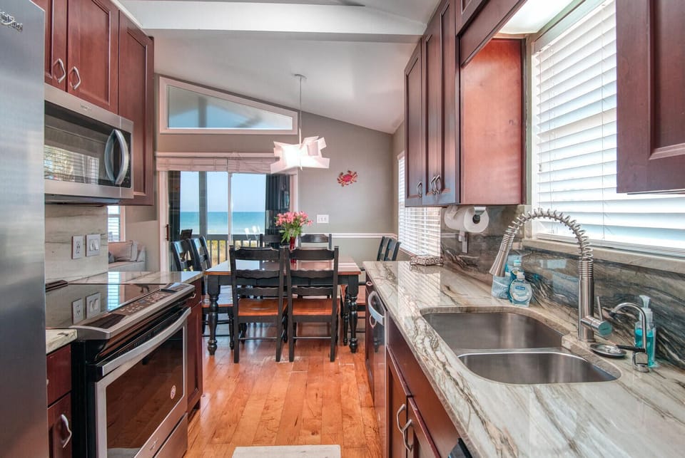 Spacious fully-equipped-granite-top kitchen and dining room overlooking beach