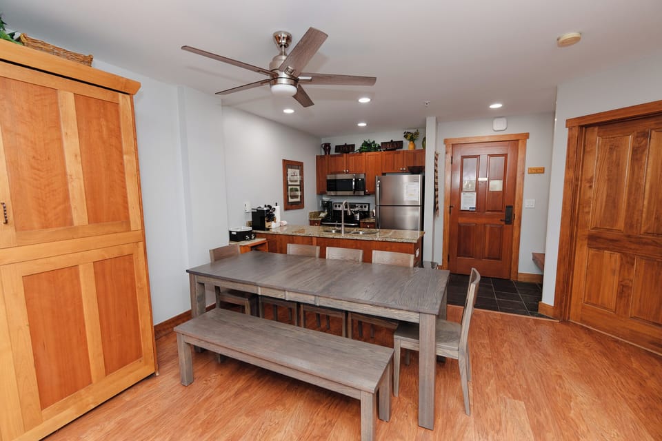Your open-concept kitchen and dining area features warm wood cabinetry, granite countertops, and a spacious table perfect for gathering with family and friends.