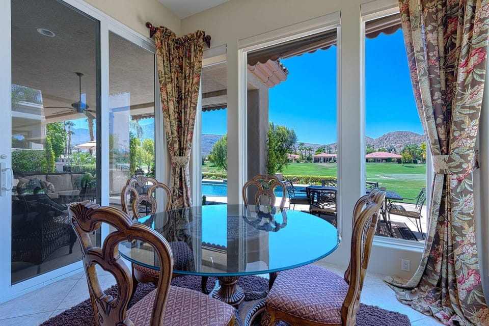 A bright and airy dining space overlooking the patio and pool
