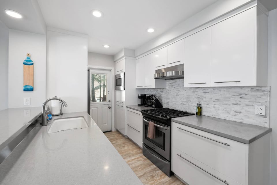 Kitchen with gas stove, dishwasher, microwave and fridge