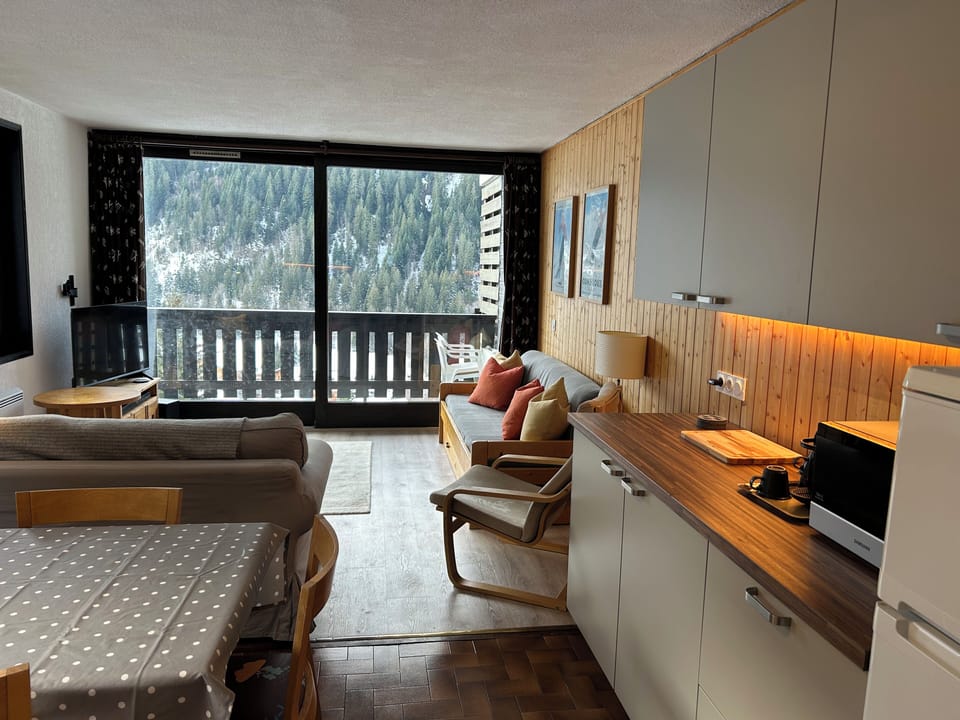 Spacious open plan living space with sliding doors and balcony extensive views