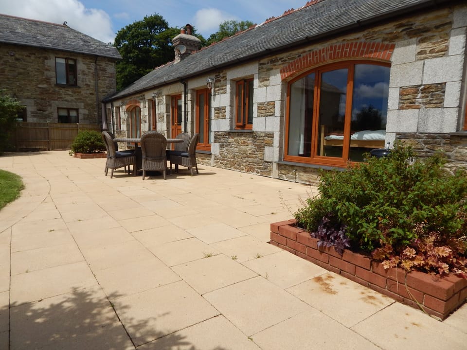 Large patio with high-quality furniture (inc parasol) and bbq.