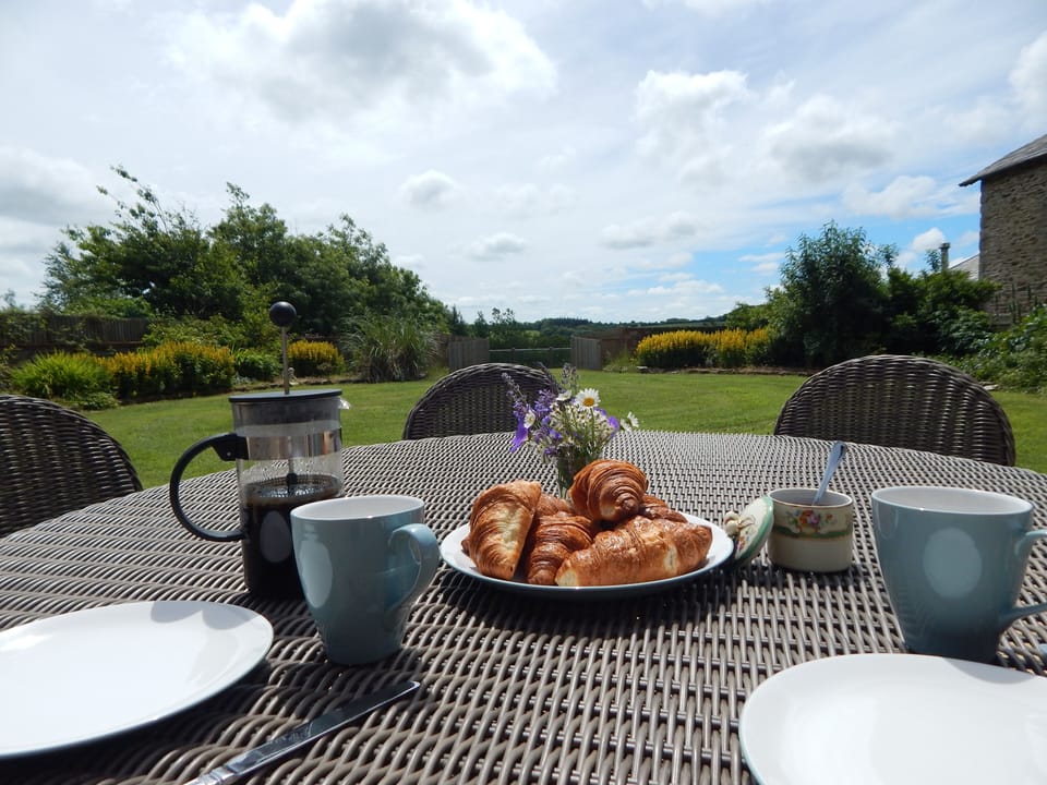 The garden is sunny and welcoming, and overlooks the lake beyond.