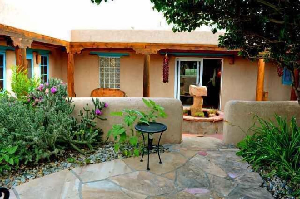View to sunken courtyard with grill, covered portal area extends outdoor living in any kind of weather