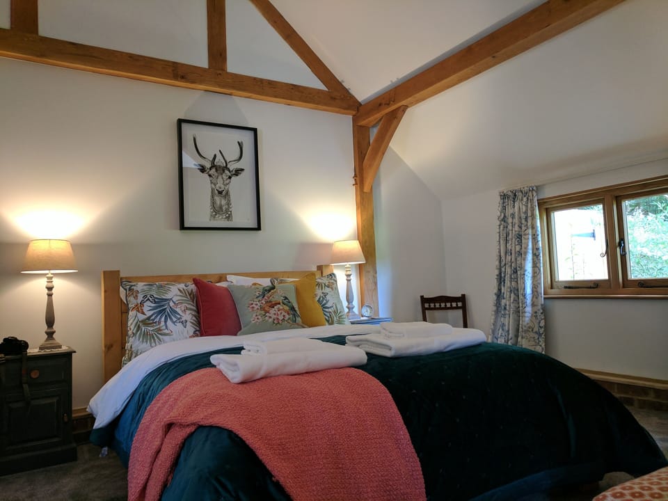 Chunky oak framed king size bed with Egyptian cotton linens