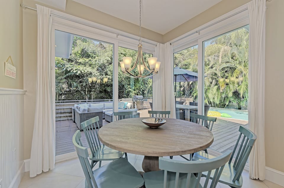 Dining room has double set sliders that offer copious natural lighting