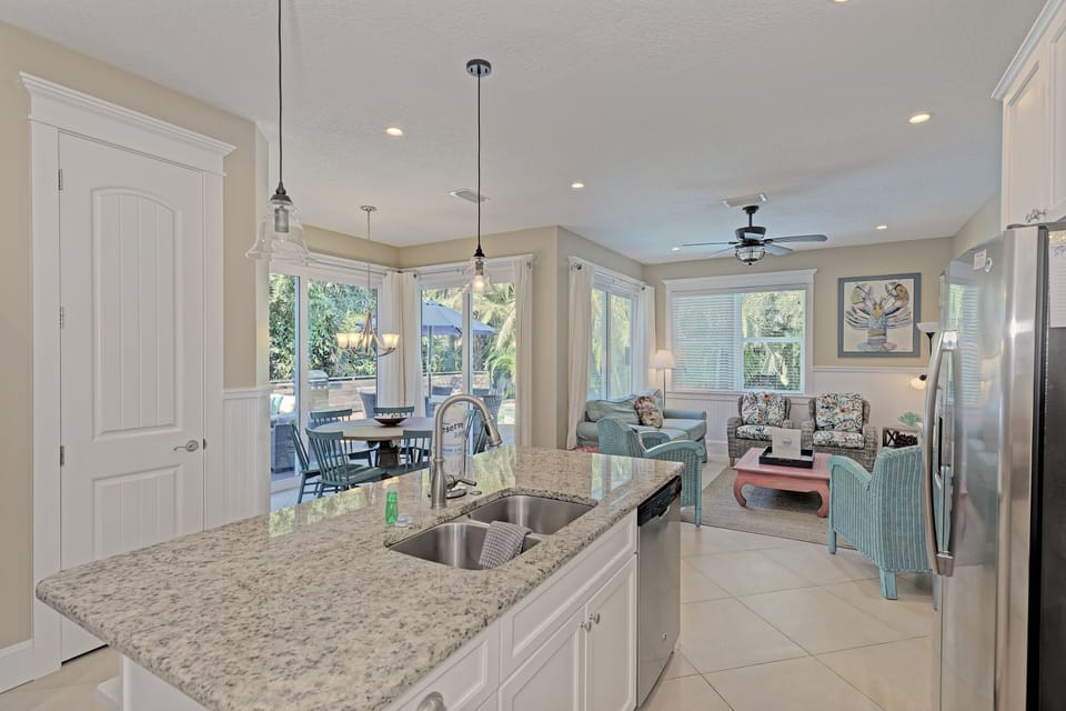 Large picturesque windows fill the living, dining and kitchen with natural lighting