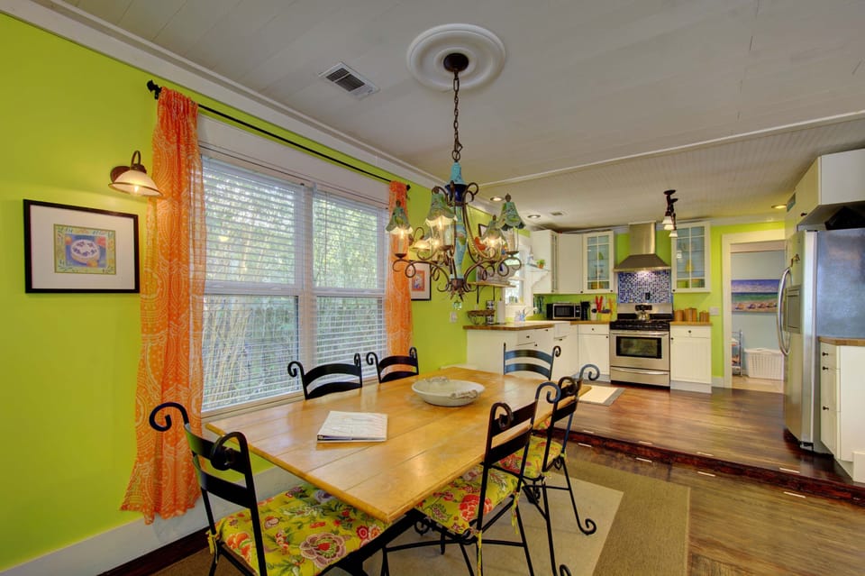 Dining Area with Natural Light – St. Simons Beach Rental - Gather for shrimp and grits or late-night card games in this bright, cheerful dining space. Big windows and bold colors keep the energy high, just like the island outside your door.