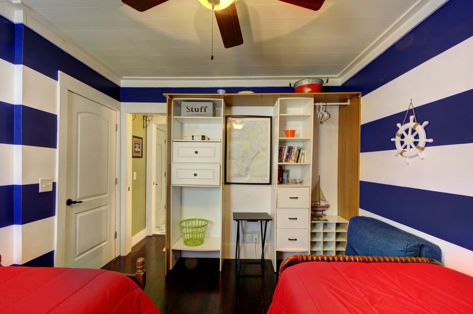 Twin Bedroom with Built-In Book Nook - Two twin beds, blackout shutters, and extra storage make this room useful for kids, friends, or anyone who packed half the house.