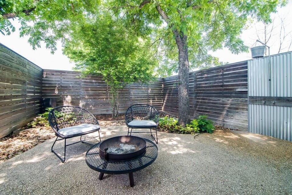 Courtyard fire pit – gather under the trees with outdoor seating.
