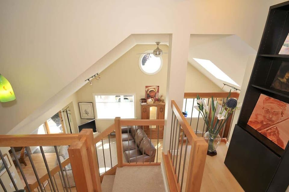 The lofted ceiling of the cottage, lovely wood work accents, and large windows create a bright and open ambiance which is carried throughout the residence.