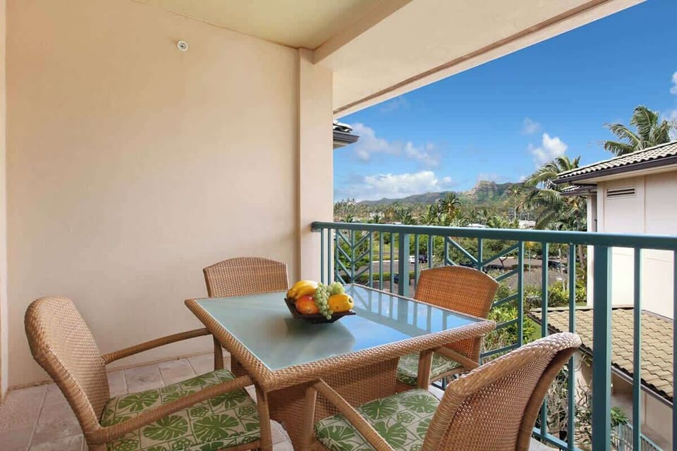 Private balcony with outdoor seating and tropical garden views