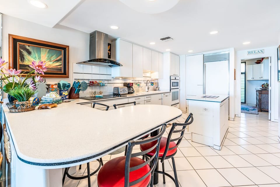 Subzero fridge and peninsula with bar stools.
