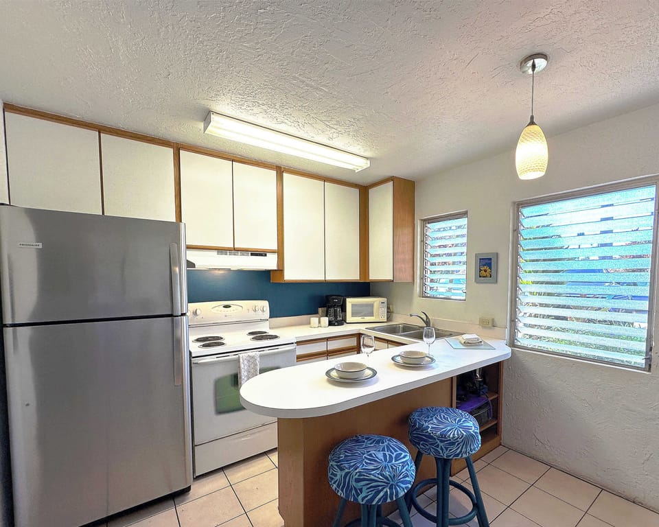 Fully stocked kitchen with a cozy bar for two! Perfect for morning coffee or sunset cocktails.
