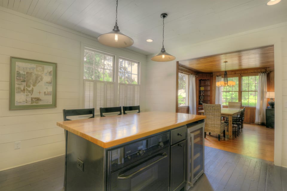 Kitchen To Dining Room View - The island sits between the kitchen and dining room, keeping prep, serving, and group meals close together.