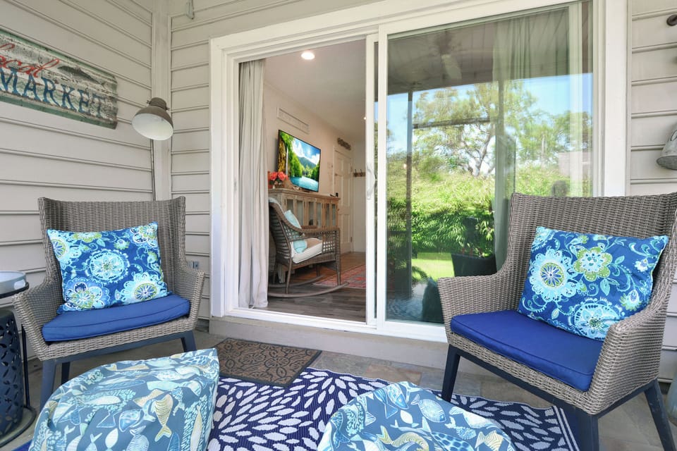 Screened Patio – Ocean Walk J-11 - Start your day with coffee or end it with wine on this cozy screened patio, just off the living room. Surrounded by greenery and styled with plush seating, it’s a peaceful place to soak in island time.
