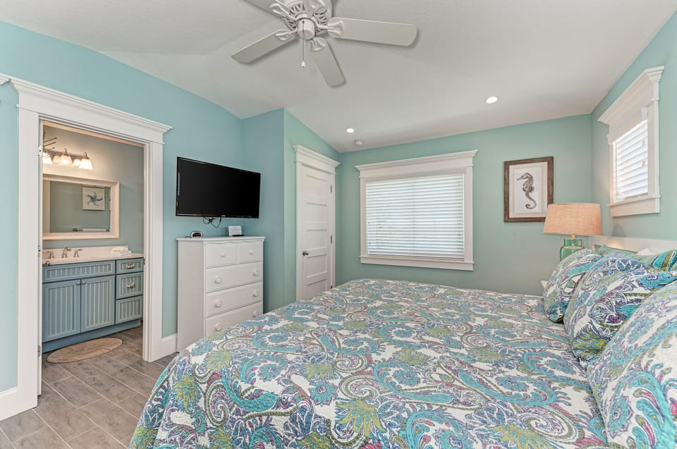 Master bedroom with en suite bathroom and TV