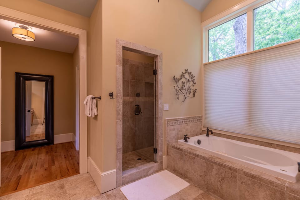 Soak away the day in the tile-surround tub or rinse off in the walk-in shower, all with tree views right outside the window.