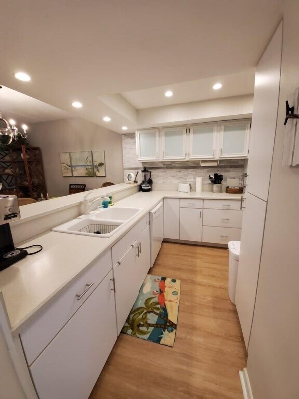 Modern kitchen with bright lighting and all necessary amenities for cooking.