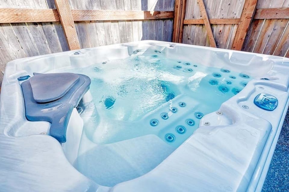 Relax in the private hot tub at Bloomer Mansion, your luxurious retreat for the perfect getaway.