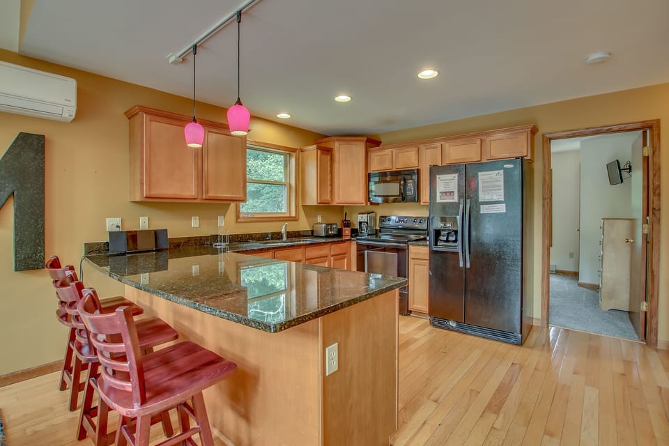 kitchen view with several chairs and a refrigerator