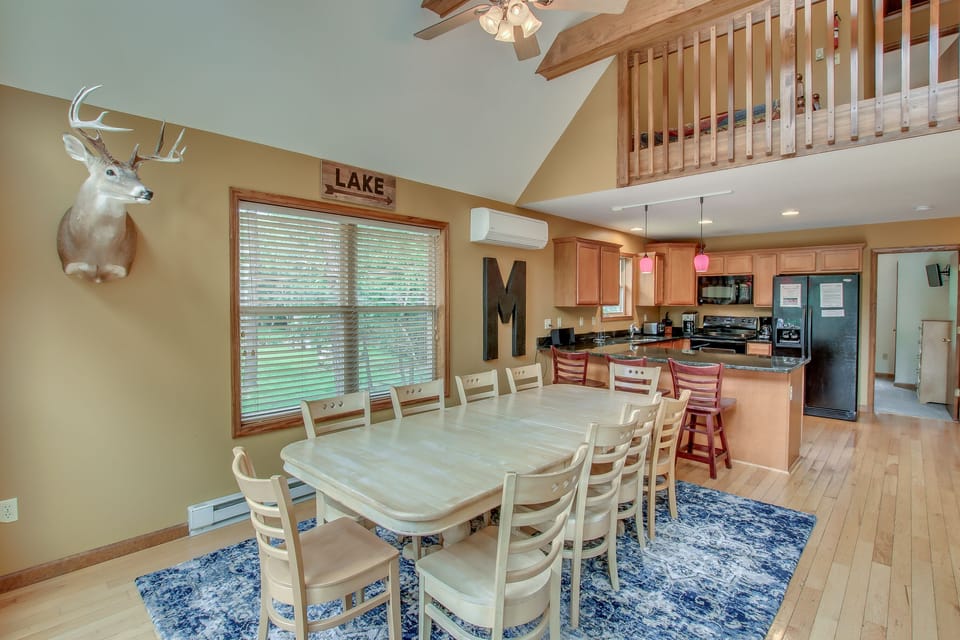 dining room table and mounted deer head on wall