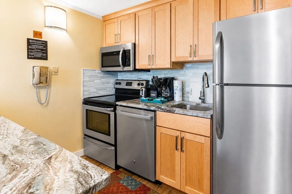 Bright and open kitchen featuring upgraded cabinets, full-size appliances, and plenty of counter space.