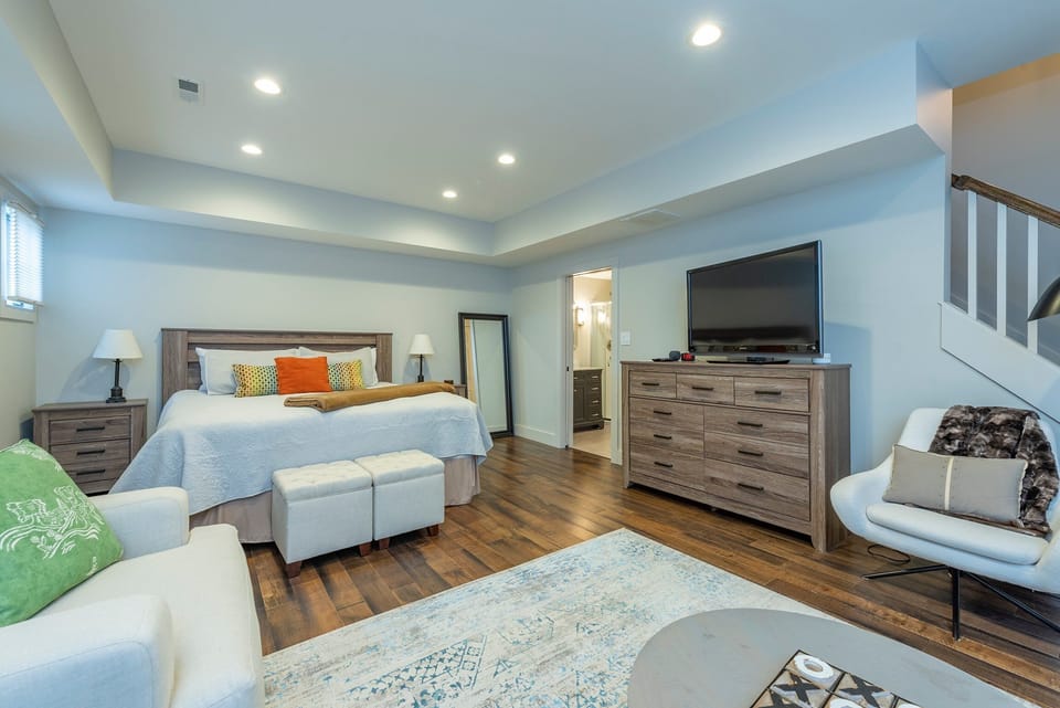 Lower-level bedroom with King bed & updated living area with new Roku-based LCD Smart TV.