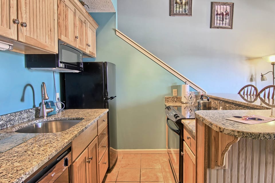 Kitchenette - There are granite counter tops in the kitchen, one housing the stainless steel sink and the table with seating for three. There is full stove, microwave, coffee maker, toaster, dishwasher and an average sized refrigerator
